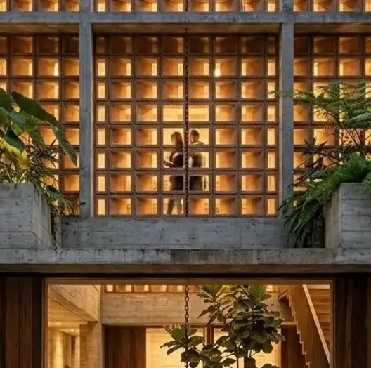 The lattice facade lit from within at night